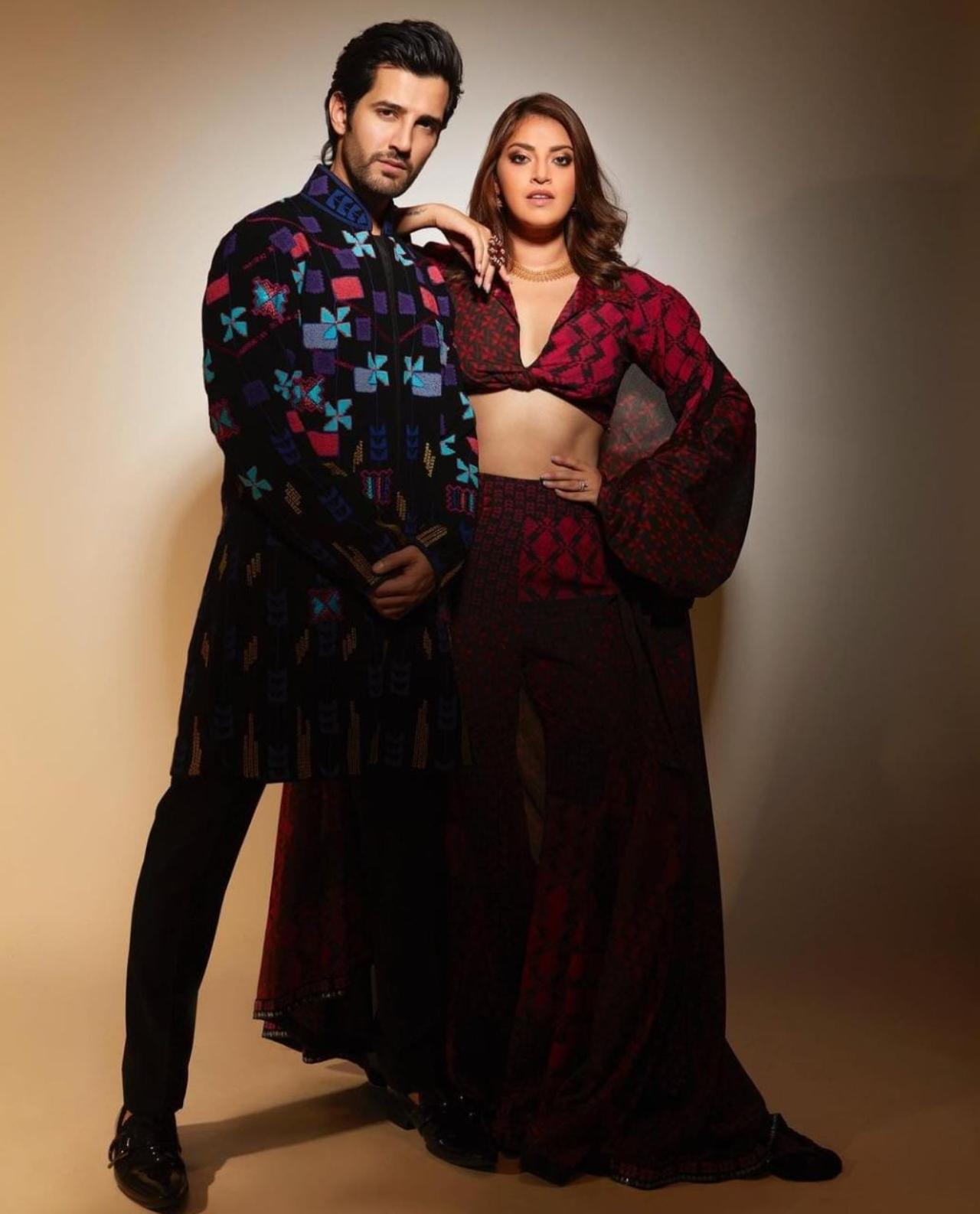Well the best is always at the end, to end this perfect couple goal list we have a beautiful shot of Aditya and Anushka wearing modern traditional outfits. Aditya looks ravishing as he wears a traditional kurta with geometrical designs printed on it, whilst Anushka is caught in a sensational modern traditional red two piece with multi structured designs printed on it. The couple together make a smashing pair.